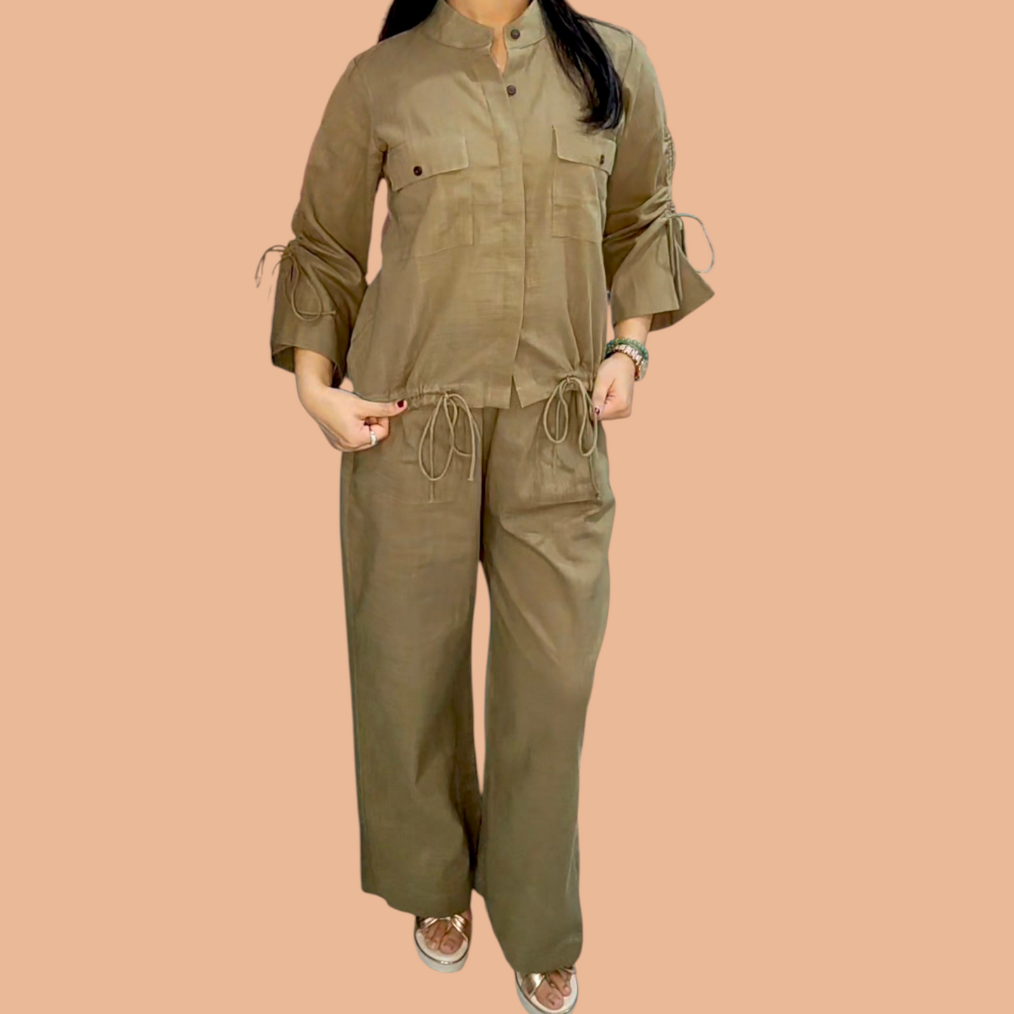 Person wearing a mud brown jumpsuit on a beige background